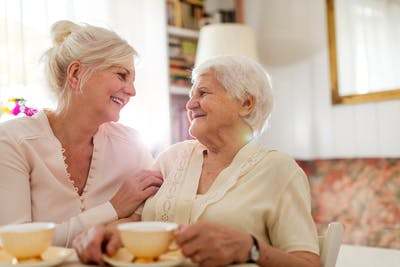 woman-having-tea-with-and-helping-someone-who-had-a-stroke